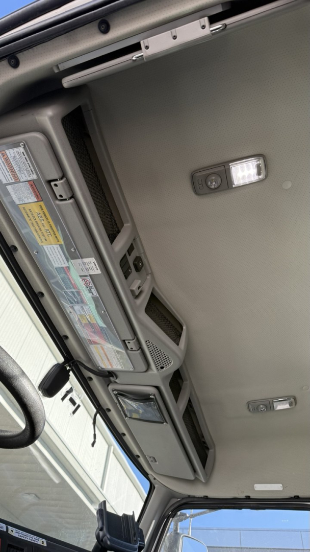 Volvo VNR300 interior dash area with overhead console and control panels in view.