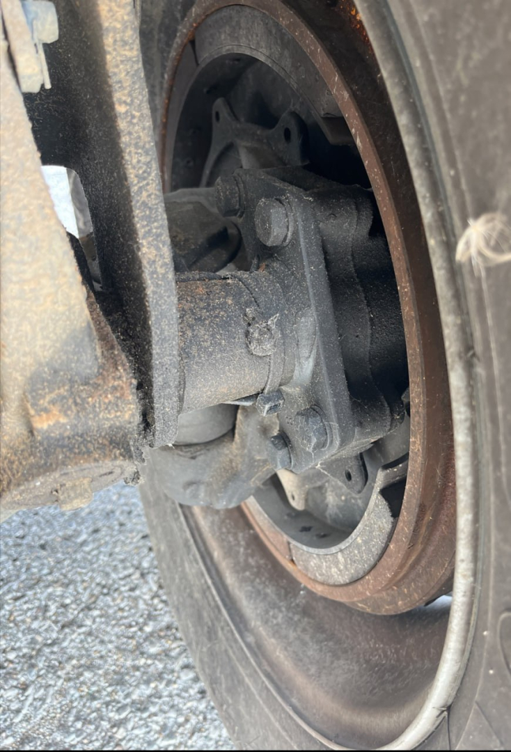 Volvo VNR300 wheel hub and brake drum close-up showing axle components