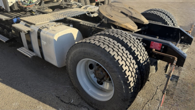Volvo VNR300 4x2 single axle day cab chassis showing dual rear wheels, fuel tank, and frame components.