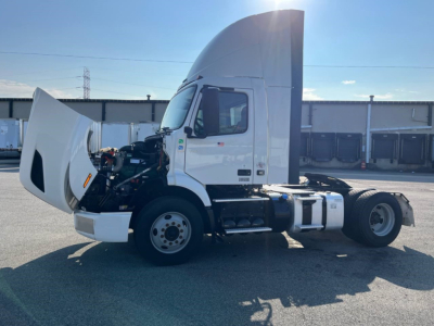 Volvo VNR300 4x2 single axle day cab with hood open showing engine compartment and side view of cab.