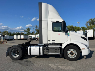 Volvo VNR300 4x2 day cab tractor side view showing fuel tanks and chassis label text on door