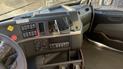 Volvo VNR300 dashboard and steering wheel in-cab showing control panels and gear selector.