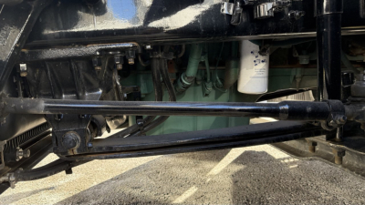 Vehicle undercarriage showing suspension and drivetrain components of a 2022 Volvo VNR300 day cab truck.