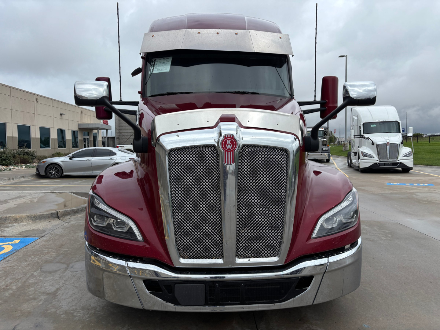 Kenworth T680 truck front view showing chrome grille and dual large headlights