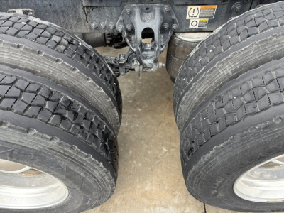 Kenworth T680 rear dual wheels view showing drivetrain and suspension components with tires and wheel hubs.