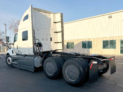 Truck chassis with sleeper cab showing rear view of International LT625 tractor and dual rear axles.