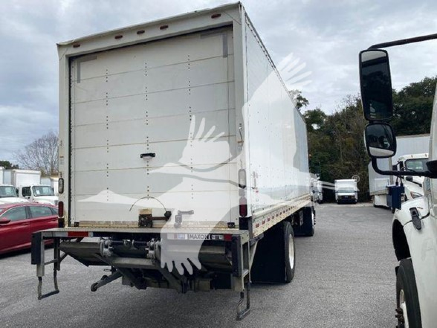 Isuzu FTR box truck rear view showing cargo area and hitch attachments.