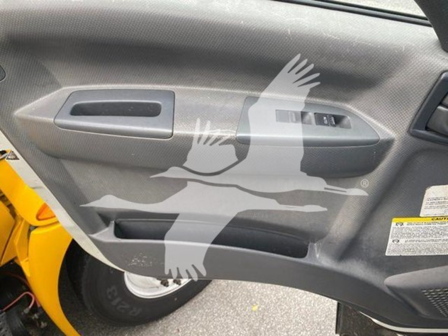Isuzu FTR interior door panel with power window controls and storage pocket visible.