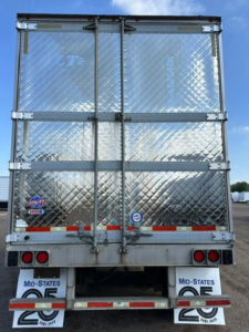 Rear view of 2016 utility refrigerated trailer with diamond-plate aluminum doors and dual rear doors