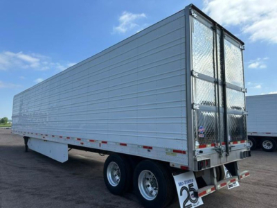 Trailer side and rear showing a refrigerated utility trailer with silver aluminum sides and diamond plate rear doors.