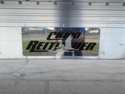 CK-100 trailer plate with Reitnouer logo attached to aluminum surface.
