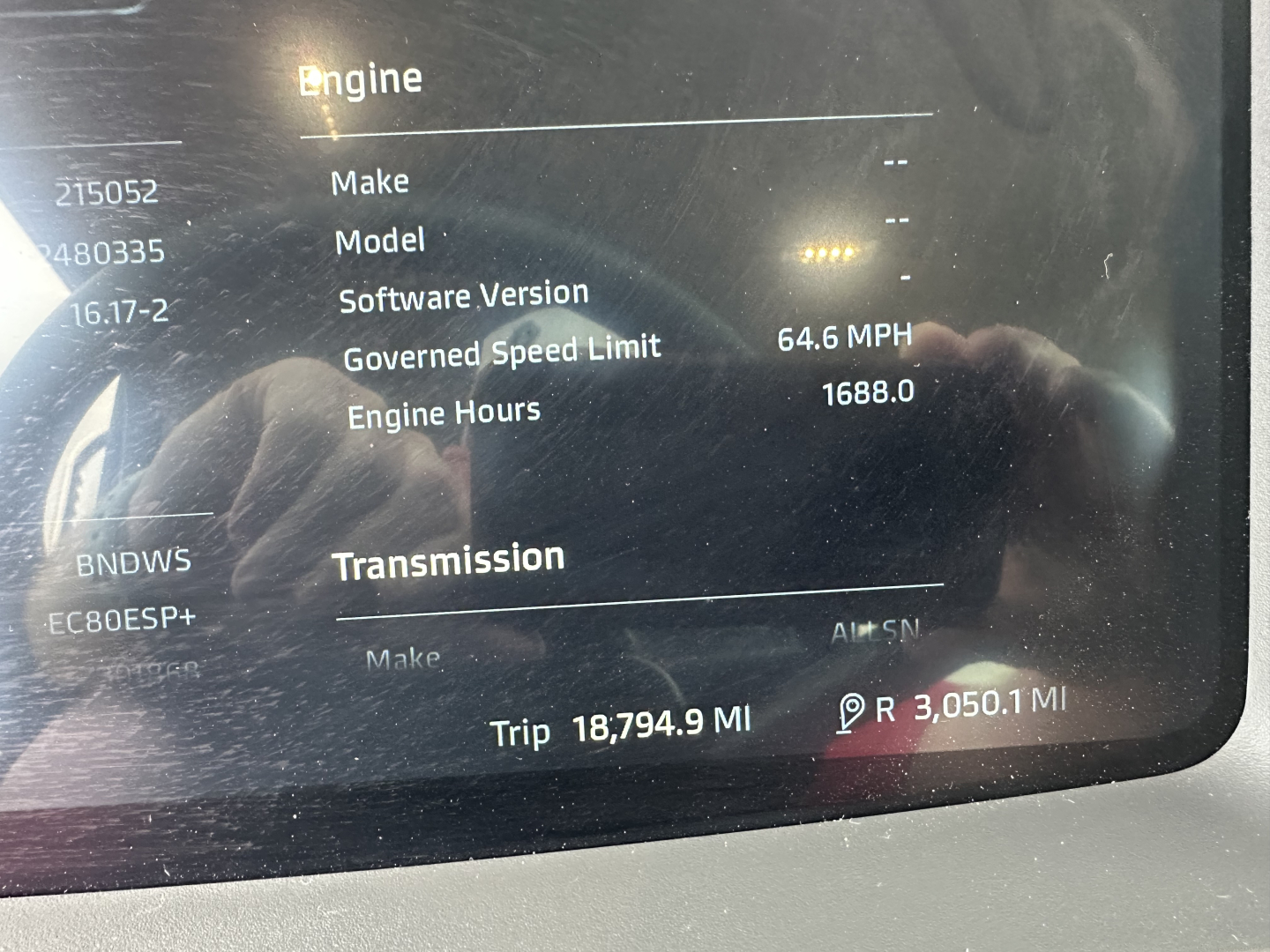 Engine display panel in Kenworth T880 showing Engine Hours 1688.0, Goverened Speed Limit 64.6 MPH, Trip 18,794.9 Mi, Engine/Transmission section with placeholders, VIN 1NKZLK0X1TJ215052 not fully visible.