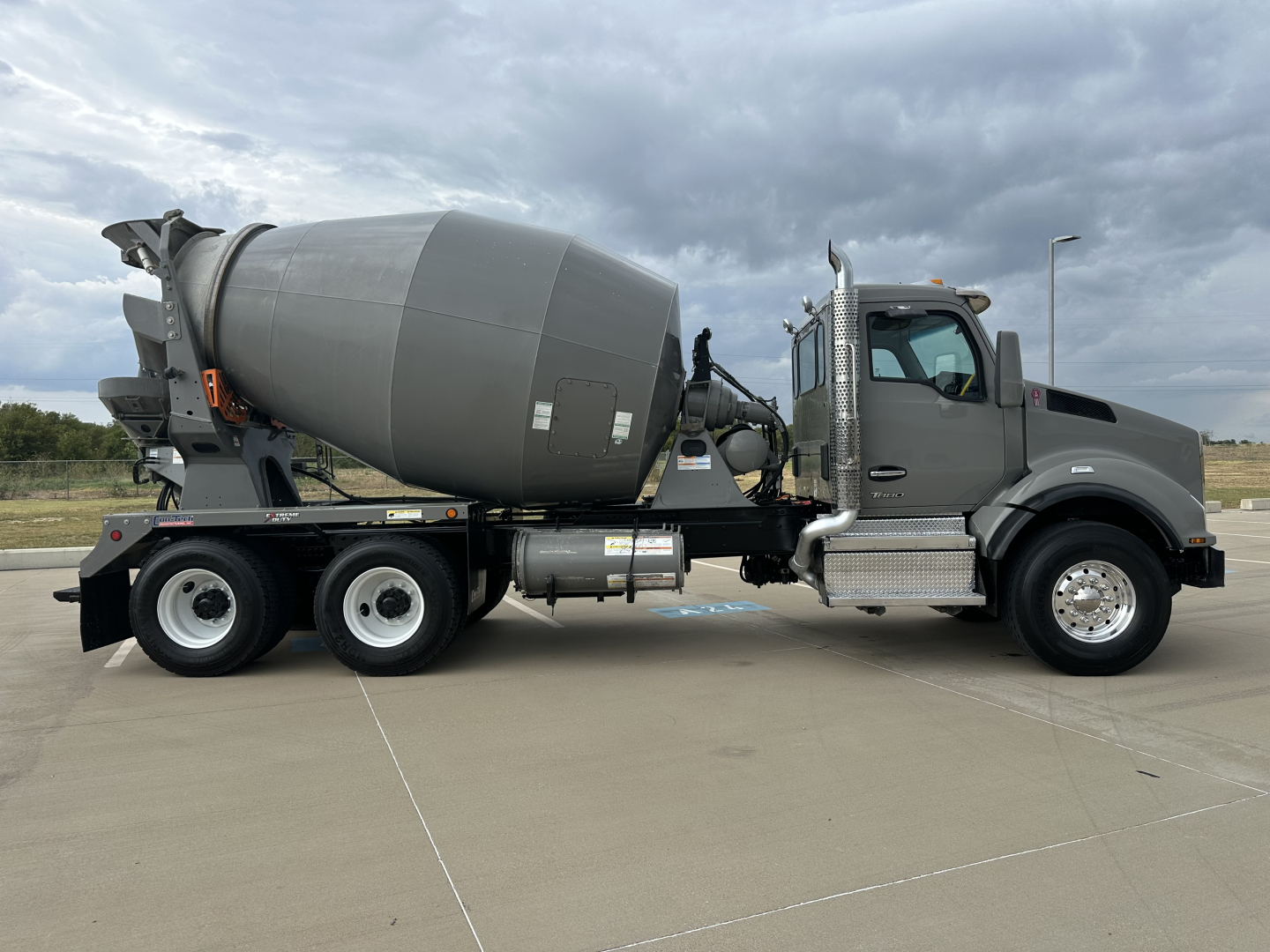 Kenworth T880 mixer truck side view with cement mixer barrel, cab, and chassis visible.