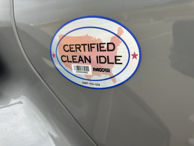 Sticker on side of Kenworth T880 showing Certified Clean Idle logo with PacCAR logo, circular outline, and barcode.