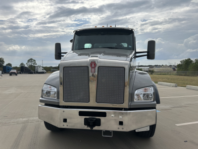 Front view of a Kenworth T880 mixer truck showing large chrome grille, dual mirrors, and heavy-duty bumper.