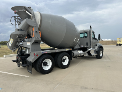 Kenworth T880 mixer truck rear-right view showing concrete mixer drum and chute assembly.