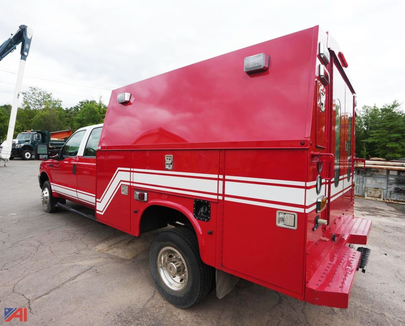 Red Ford F350 XL SD crew cab rescue vehicle side and rear view with white stripes and equipment compartments.