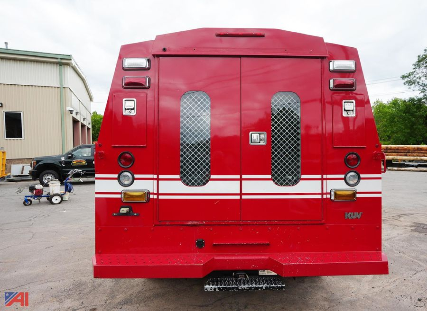Rear view of a red Ford F-350 XL SD Crew Cab rescue vehicle with white stripes and mesh vents.