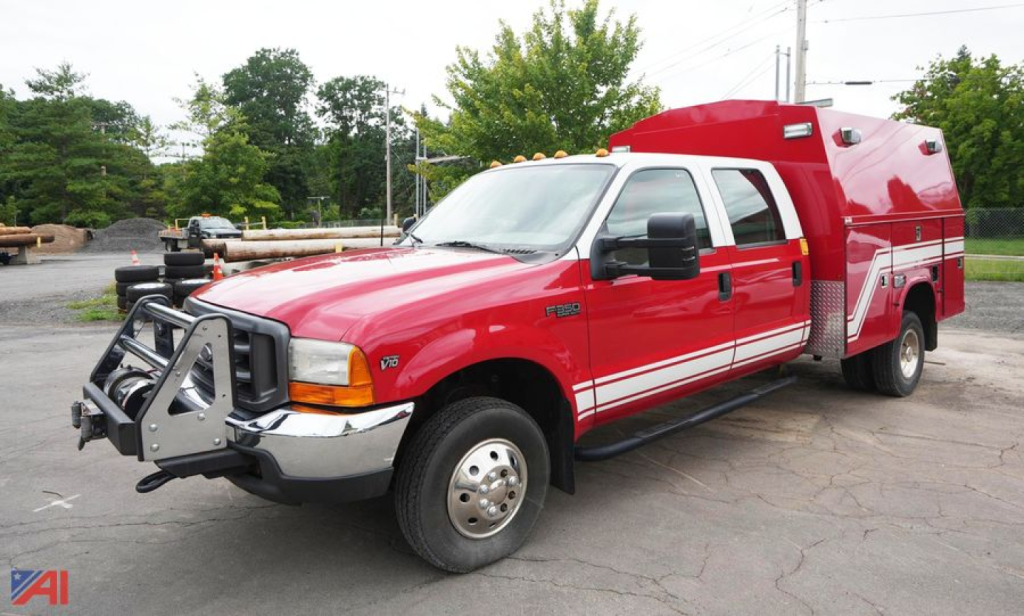 Ford F-350 XL SD crew cab rescue vehicle with red apparatus body and front grille guard, in-service truck.