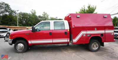 Ford F-350 XL SD crew cab rescue vehicle side view with red body and white reflective stripe, service unit compartment at rear, emergency lighting on top.