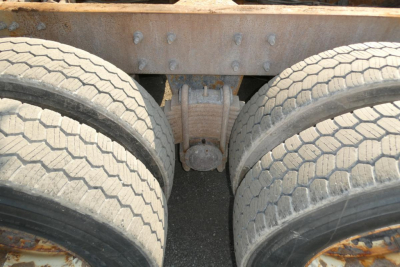 Mack GU713 truck rear showing dual rear axles and differential housing between wheels.