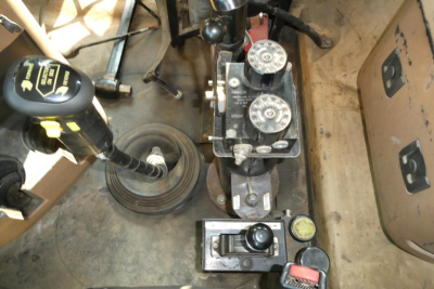 Mack GU713 dump truck interior showing gear shifter, control levers, and hydraulic controls with labels.
