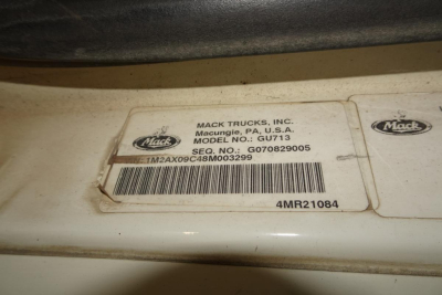 Mack Trucks inc. label on vehicle showing model GU713, VIN sticker and barcode.