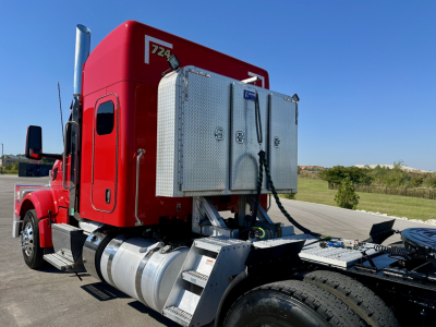 Peterbilt 567 truck cab rear with fuel tanks and diamond-plate toolbox, red sleeper cab, chrome exhaust stack, chassis side view.