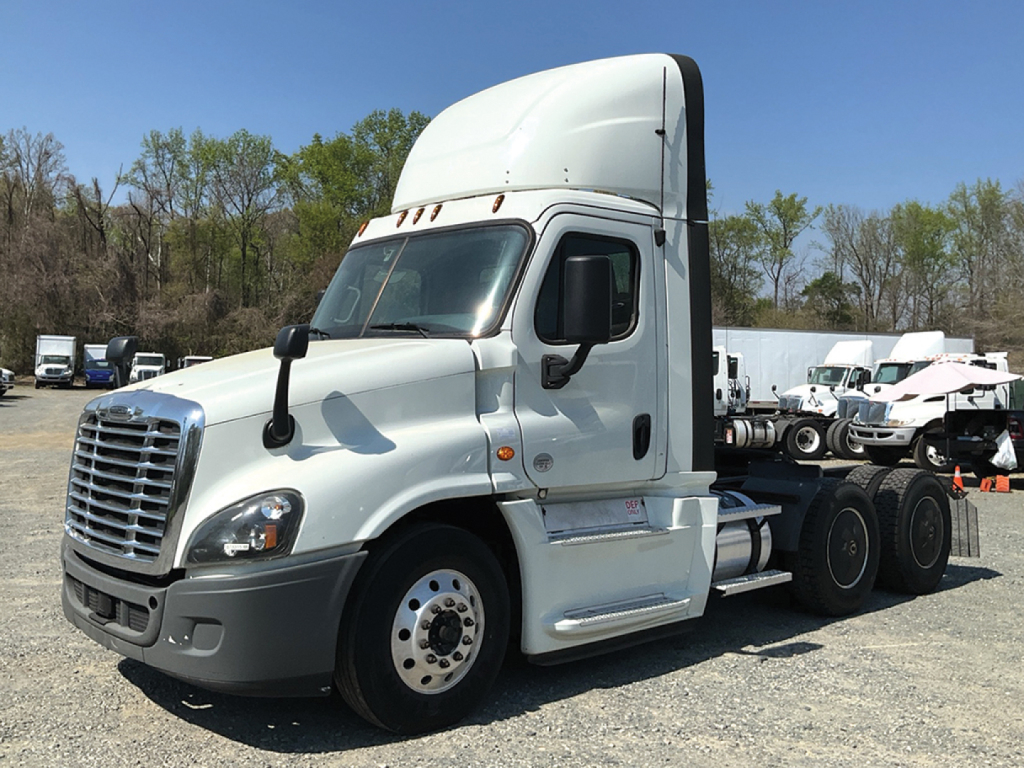 Freightliner Cascadia125 tractor-trailer in a yard, side view showing cab and wheel arches with white exterior.