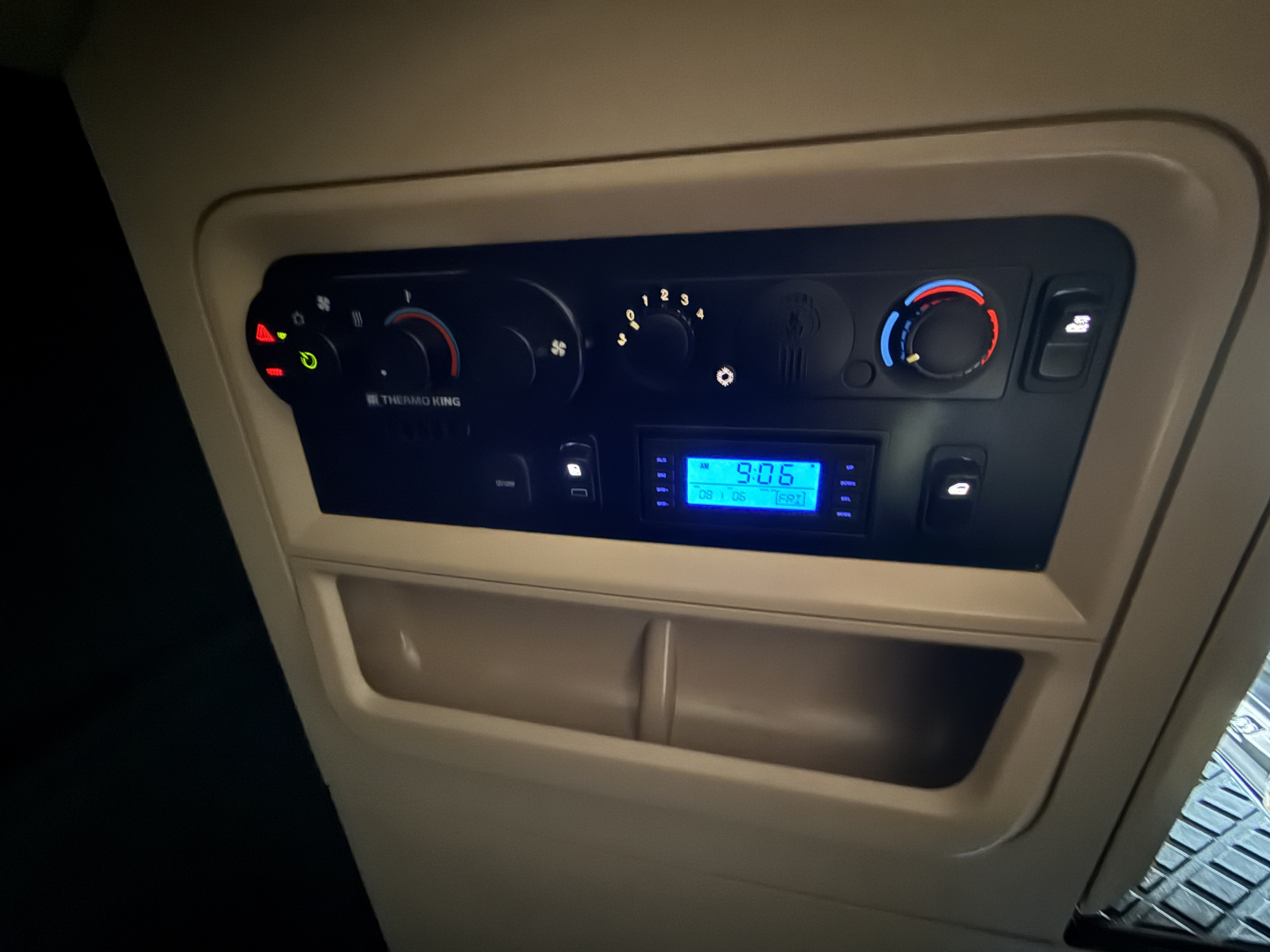 Dash of a 2023 Kenworth T680 showing climate controls, digital display, and gauge cluster in the instrument panel.