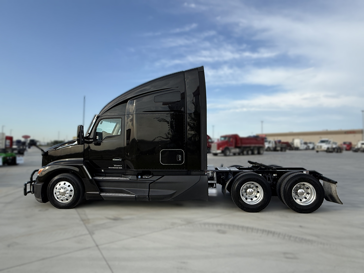 Kenworth T680 tractor side view showing sleeper cab and chassis with dual rear axles, black paint, chrome wheels.