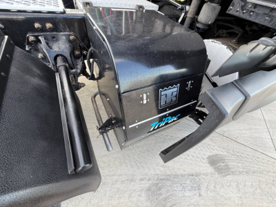 Kenworth T680 truck side view showing TiPec component and electrical box beneath cab.