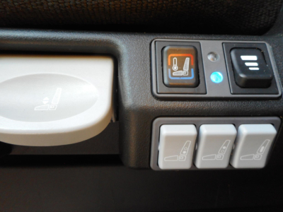 Trucks interior showing seat heater control and multiple window/seat adjustment buttons