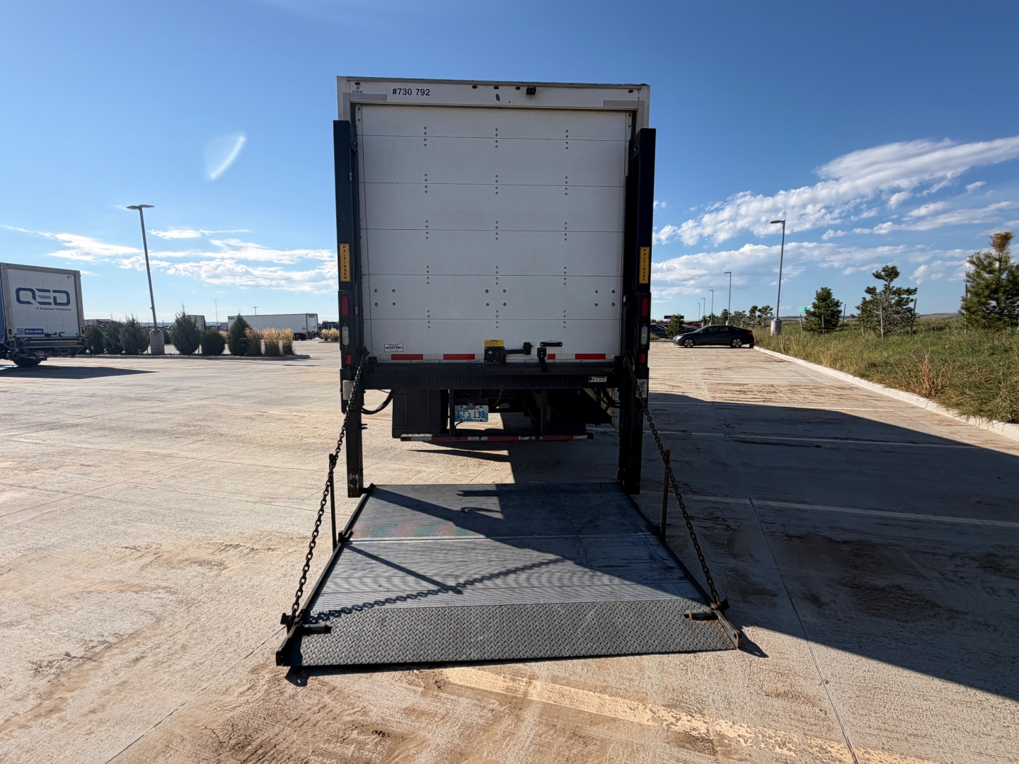Kenworth T270 box truck rear view with ramp deployed and license-free text visible on rear doors.