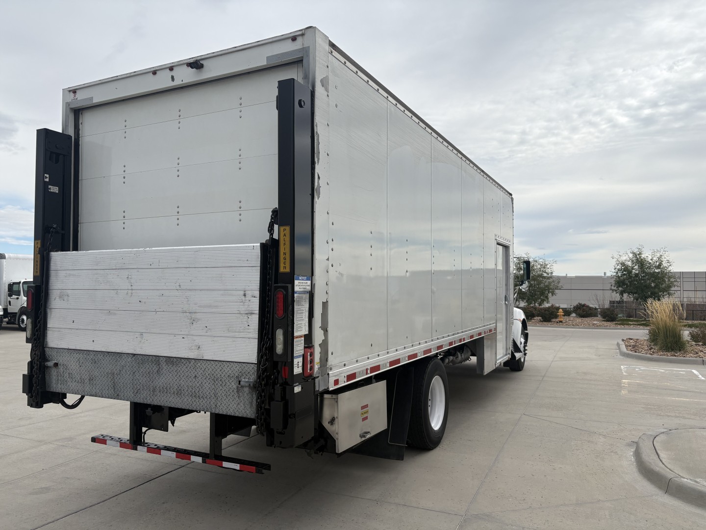 Kenworth T270 box truck rear-side view showing aluminum cargo box and rear underride guard.