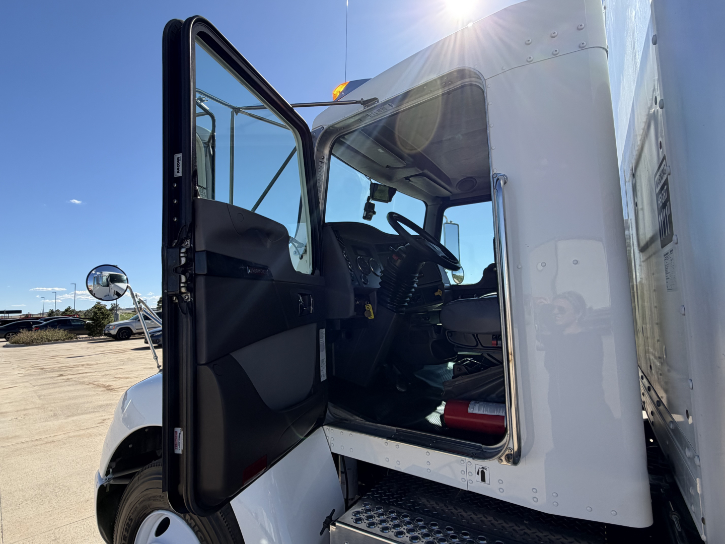 Kenworth T270 truck cab interior with open door showing steering wheel and dashboard in certificate white exterior.