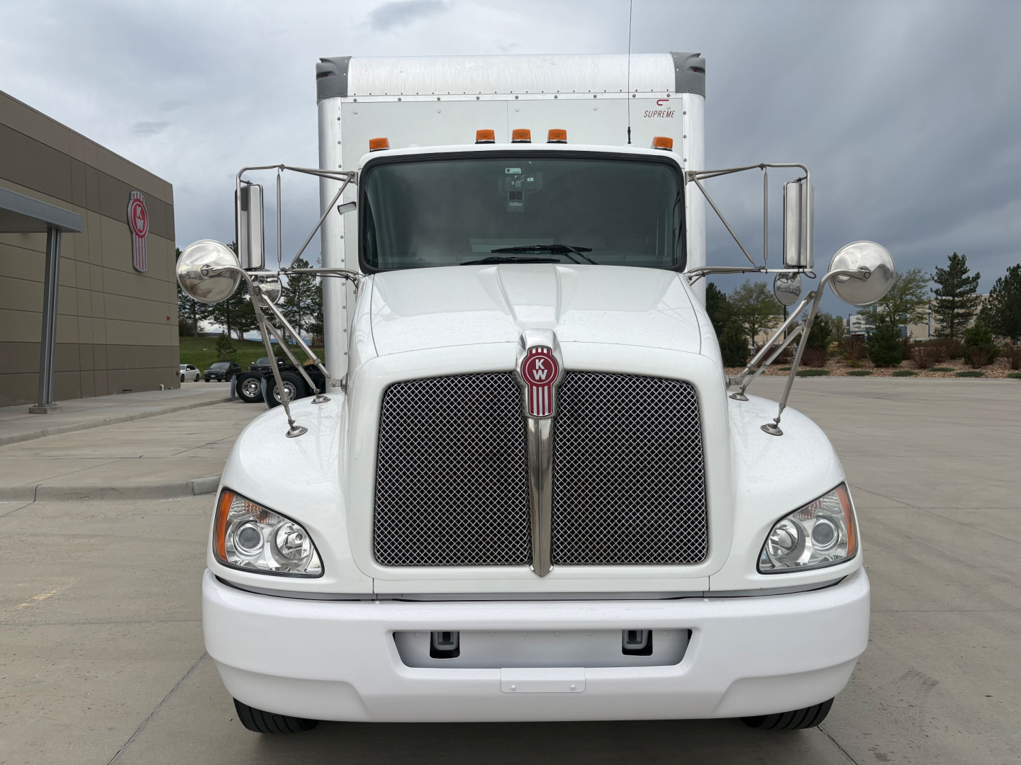 Front view of a white 2020 Kenworth T270 truck showing large vertical grille, Kenworth emblem, headlights, and side mirrors.