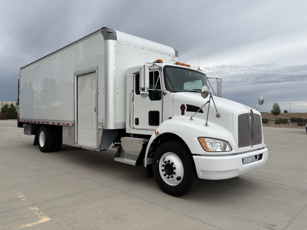 Kenworth T270 box truck showing front and side view with white cab and cargo box.