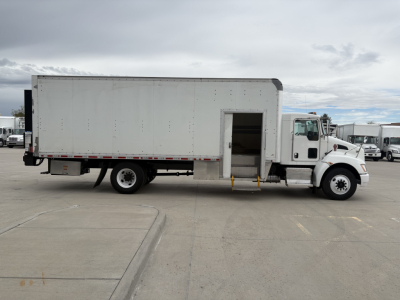 Kenworth T270 box truck side profile showing a white cargo box with a side entry door and steps, and a front cab with black tires.