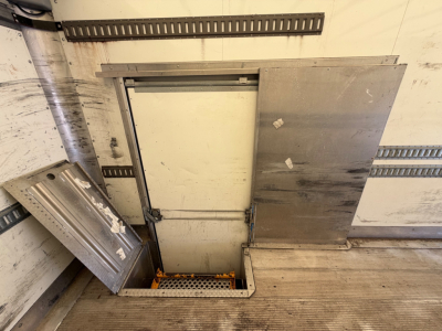 Kenworth T270 truck cargo area with side access hatch and metal panels, interior floor visible, some equipment/rails along walls.