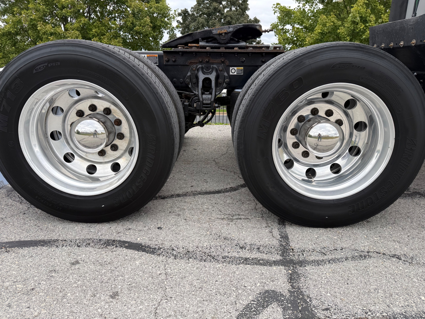 Kenworth T680 chassis showing dual rear wheel tires and trailer hitch area.