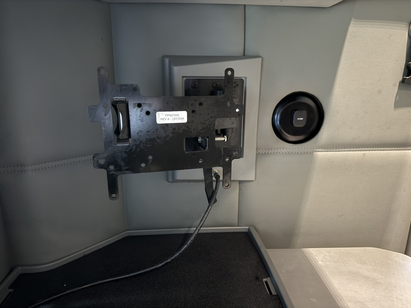 Kenworth T680 interior showing mounted electronic module with wiring and panel access.