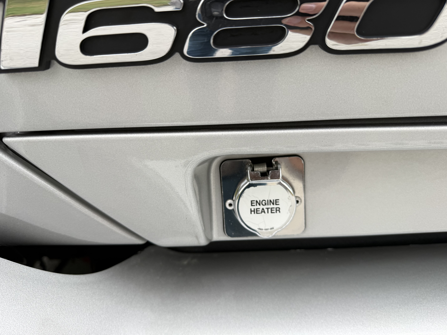 Kenworth T680 exterior rear showing engine heater inlet cap.