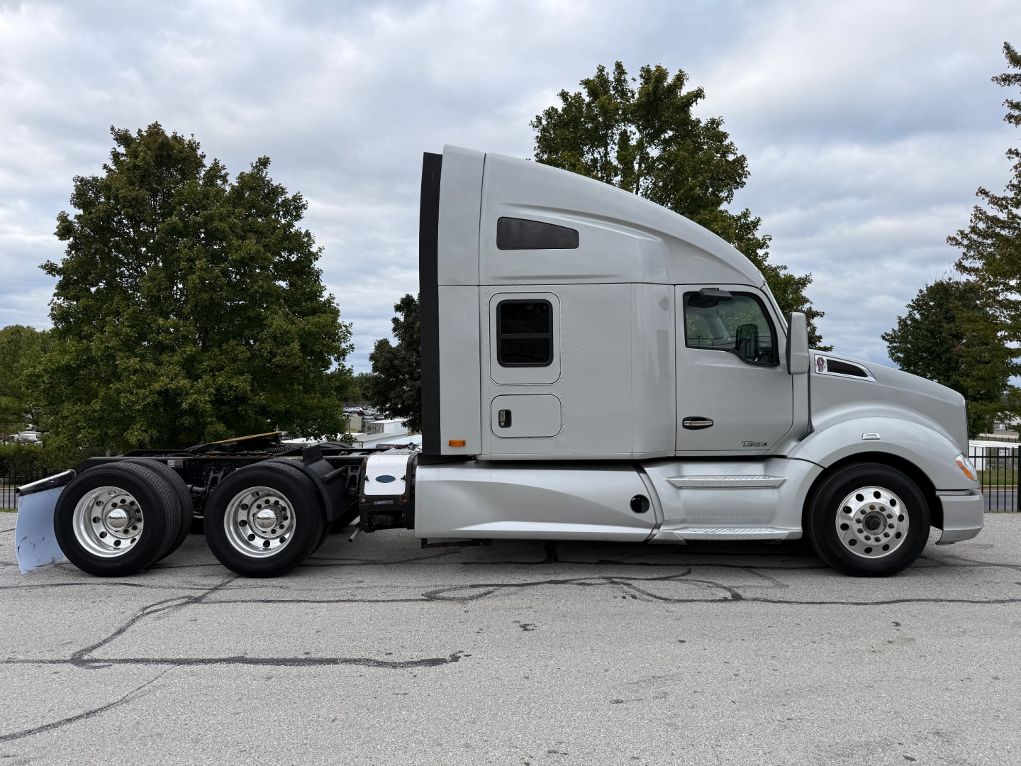 2020 Kenworth T680 side view showing sleeper cab, dual rear axles, and chrome wheels.