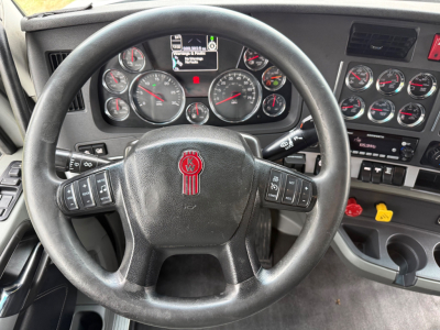 Kenworth T680 dashboard and steering wheel view showing gauges and controls.