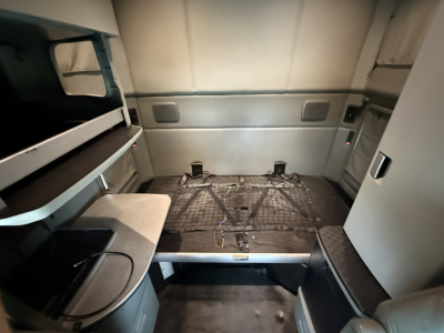 Kenworth T680 sleeper cab interior showing cargo space with bed platform and storage compartments