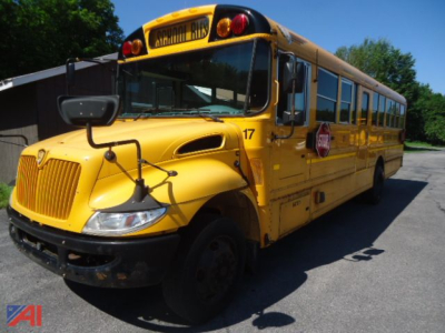 IC Corporation CE Series school bus in yellow, front-left view, with stop sign deployed, number 17 on fender, black bumper, typical school bus features.