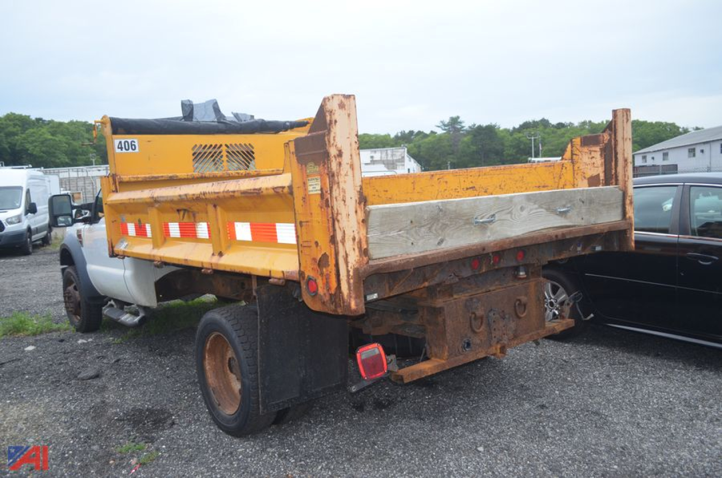 Truck bed of a 2009 Ford F550 Super Duty dump truck showing orange dump body and rear taillights
