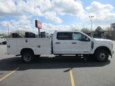 Ford F-350 service body truck side view showing utility compartments and dual rear wheels.