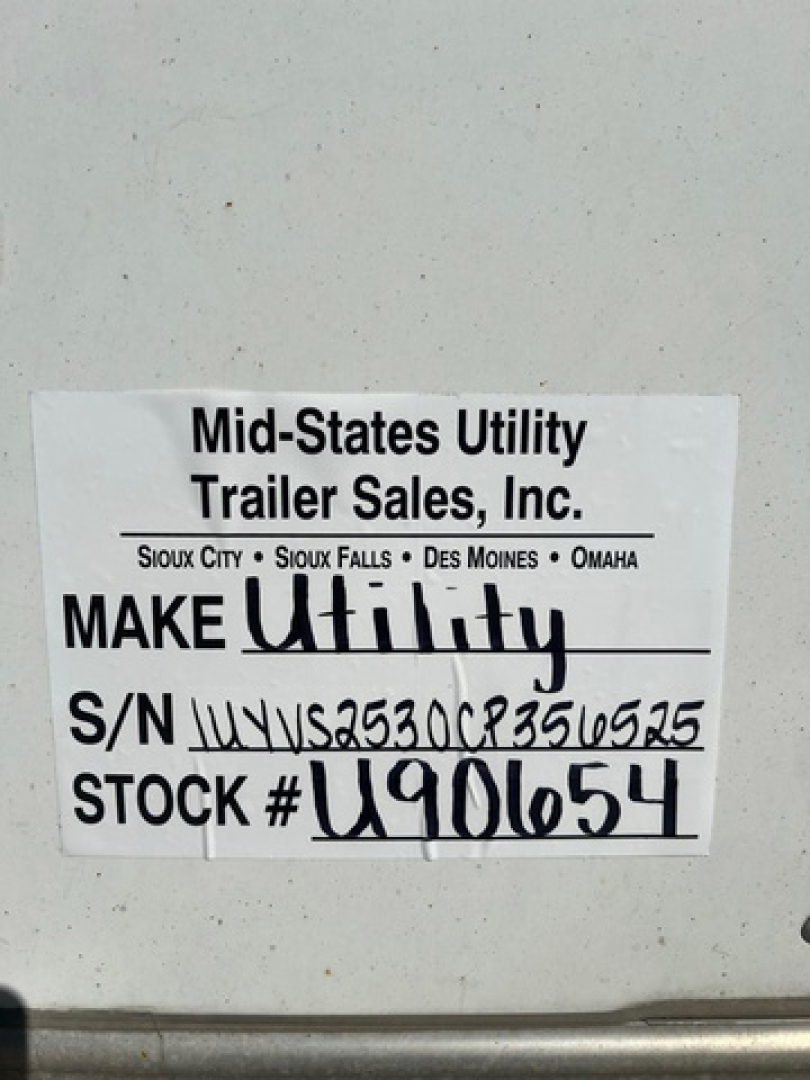 Trailer tag showing Mid-States Utility Trailer Sales, Inc. with S/N and STOCK numbers on a utility trailer.